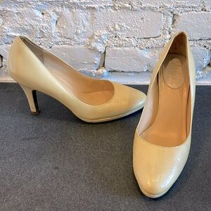 Cole Haan, patent leather cream pumps with Nike Air.